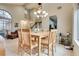 Open-concept dining area with lots of natural light, tile floors, high ceilings and arched windows at 8253 Ruby Mountain Way, Las Vegas, NV 89128