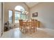 Bright dining area with tile flooring, a chandelier, wooden table and large windows at 8253 Ruby Mountain Way, Las Vegas, NV 89128