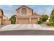 Exterior shot of a two-story home featuring a 3-car garage and large arched window above the garage at 8253 Ruby Mountain Way, Las Vegas, NV 89128