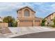 Inviting two-story house with a three-car garage and a well-maintained front yard with desert landscaping at 8253 Ruby Mountain Way, Las Vegas, NV 89128
