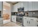Bright kitchen features white cabinets, stainless steel appliances, and a dining area just through the doorway at 8253 Ruby Mountain Way, Las Vegas, NV 89128