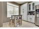 Kitchen view with a breakfast nook and ample white cabinet storage in a brightly lit setting at 8253 Ruby Mountain Way, Las Vegas, NV 89128