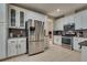 Modern kitchen with white cabinetry, stainless steel appliances, tile backsplash, and tile flooring at 8253 Ruby Mountain Way, Las Vegas, NV 89128
