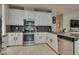 This well-lit kitchen offers white cabinets, stainless steel appliances, tile backsplash, and tiled flooring at 8253 Ruby Mountain Way, Las Vegas, NV 89128