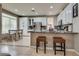 Open-concept kitchen featuring an island with barstool seating, a breakfast nook, and stainless steel appliances at 8253 Ruby Mountain Way, Las Vegas, NV 89128