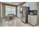 Kitchen with stainless steel refrigerator, an adjacent breakfast nook, and ample cabinet storage at 8253 Ruby Mountain Way, Las Vegas, NV 89128