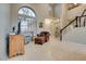 Bright living room featuring tile flooring, tall ceilings and arched windows at 8253 Ruby Mountain Way, Las Vegas, NV 89128