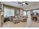 Bright, open-concept living room with a fireplace, comfortable seating, and an adjacent modern kitchen at 8253 Ruby Mountain Way, Las Vegas, NV 89128