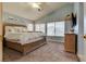 Bright main bedroom features large windows, vaulted ceiling, and stylish decor at 8253 Ruby Mountain Way, Las Vegas, NV 89128