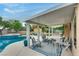Outdoor patio area featuring a pool, outdoor furniture, and a covered structure at 8253 Ruby Mountain Way, Las Vegas, NV 89128