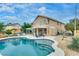 Serene backyard featuring a private in-ground pool and spa with a covered patio for outdoor relaxation at 8253 Ruby Mountain Way, Las Vegas, NV 89128