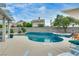 Inviting in-ground pool with a decorative tile border and a sun-soaked patio at 8253 Ruby Mountain Way, Las Vegas, NV 89128