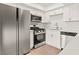 Well-equipped kitchen with stainless steel appliances, sleek white cabinetry, and stone countertops offering modern appeal at 829 Rock Springs Dr # 201, Las Vegas, NV 89128