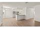 Open living area showcasing new flooring, modern lighting, and an eat-in kitchen island with an adjacent pantry at 829 Rock Springs Dr # 201, Las Vegas, NV 89128