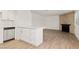Open floor plan showcases a brick fireplace, kitchen with stainless appliances, and wood floors at 829 Rock Springs Dr # 201, Las Vegas, NV 89128
