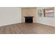 Living room features a fireplace with brick surround and a window for natural light at 829 Rock Springs Dr # 201, Las Vegas, NV 89128