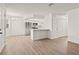 Bright living room featuring a modern kitchen and light wood flooring throughout at 829 Rock Springs Dr # 201, Las Vegas, NV 89128