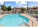 Inviting community pool and spa area with mature landscaping and lounge seating for relaxing and enjoying the outdoors at 829 Rock Springs Dr # 201, Las Vegas, NV 89128