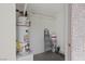 Utility room with modern water heater and storage shelving, providing efficient space for essential home systems at 829 Rock Springs Dr # 201, Las Vegas, NV 89128