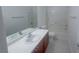 Bright bathroom features a shower-tub combo and vanity with cherry-wood cabinets at 9148 Alluring Ave, Las Vegas, NV 89149