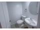 Half bath includes modern fixtures, a pedestal sink, and a neutral color palette at 9148 Alluring Ave, Las Vegas, NV 89149