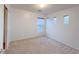 Carpeted bedroom features neutral walls and multiple windows for ample natural light at 9148 Alluring Ave, Las Vegas, NV 89149