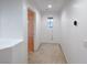 Bright hallway features neutral carpet, natural light from the window, and an open doorway at 9148 Alluring Ave, Las Vegas, NV 89149