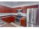 Modern kitchen featuring stainless steel appliances and rich wood cabinetry at 9148 Alluring Ave, Las Vegas, NV 89149