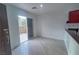 Bright living room featuring wood-look tile floors and access to the outdoor patio through sliding glass doors at 9148 Alluring Ave, Las Vegas, NV 89149