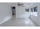 Spacious living room with wood-look floors, contemporary ceiling fan, and staircase access at 9148 Alluring Ave, Las Vegas, NV 89149