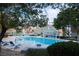 Community pool with blue lounge chairs and covered patio area at 9148 Alluring Ave, Las Vegas, NV 89149