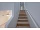 Carpeted staircase with white walls leads to the upper level of the home at 9148 Alluring Ave, Las Vegas, NV 89149
