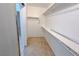 Walk-in closet with shelving and bars, neutral carpet, and access to the bathroom at 9148 Alluring Ave, Las Vegas, NV 89149
