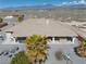Aerial view of backyard with covered patio, hot tub, chairs, desert landscaping, and scenic mountain view at 961 Laguna St, Pahrump, NV 89048