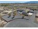 Aerial view of a desert home showing the landscape, pebble yard, covered patio, and circular driveway at 961 Laguna St, Pahrump, NV 89048