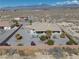 Well-maintained backyard featuring desert landscaping, brick fence, desert surroundings, and covered patio at 961 Laguna St, Pahrump, NV 89048