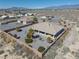 Well-maintained backyard with desert landscaping, desert view, and covered patio at 961 Laguna St, Pahrump, NV 89048