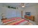 Cozy bedroom featuring a striped bedspread, ceiling fan, and large double door closet at 961 Laguna St, Pahrump, NV 89048