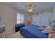 Neutral bedroom with ceiling fan, large window, and double door closet at 961 Laguna St, Pahrump, NV 89048