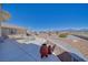 Exterior of home showcasing covered patio seating area with mountain views and rock landscaping at 961 Laguna St, Pahrump, NV 89048