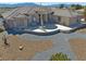 Stunning exterior of home with tile roof, stone accents, and patio with beautiful desert landscape in the background at 961 Laguna St, Pahrump, NV 89048