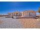 Charming single-story home featuring decorative accents and large stone yard with patio set perfect for entertaining at 961 Laguna St, Pahrump, NV 89048