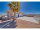 Spacious three-car garage with ample parking on a large driveway and beautifully landscaped yard with desert theme at 961 Laguna St, Pahrump, NV 89048