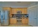 Well-lit kitchen equipped with stainless steel appliances and wood cabinets for ample storage at 961 Laguna St, Pahrump, NV 89048
