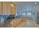 Open kitchen featuring granite countertops, tile flooring, stainless steel appliances, and a dining area at 961 Laguna St, Pahrump, NV 89048