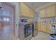 Well-equipped laundry room with cabinetry, modern appliances and adjacent dining room at 961 Laguna St, Pahrump, NV 89048