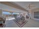Spacious covered patio with ceiling fan, perfect for outdoor dining and entertaining with views of the backyard at 961 Laguna St, Pahrump, NV 89048