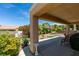 Inviting covered patio and landscaped backyard with lush greenery and seating areas, perfect for outdoor enjoyment at , Henderson, NV 89044