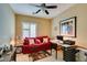Bedroom or home office includes a red sofa, large window, ceiling fan, and desk at , Henderson, NV 89044