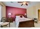 Comfortable bedroom with accent wall, ceiling fan, and stylish furnishings for a relaxing ambiance at , Henderson, NV 89044